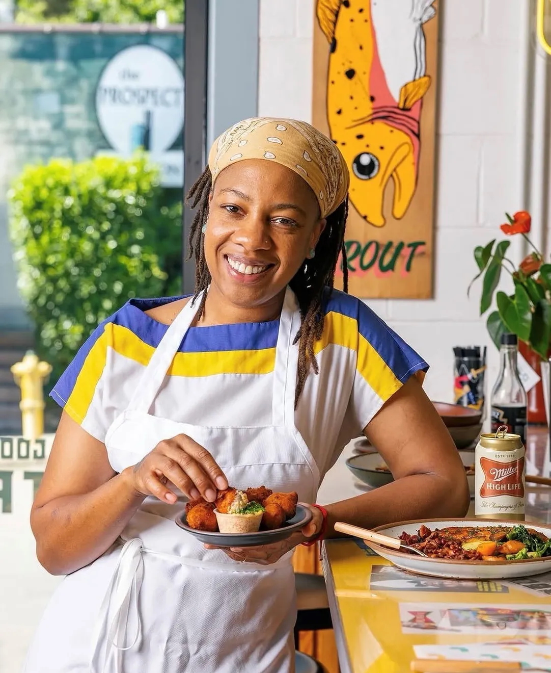 Chef Ashleigh Shanti serving a plate of food